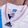 Présente le col du maillot OM Ligue des Champions 1993