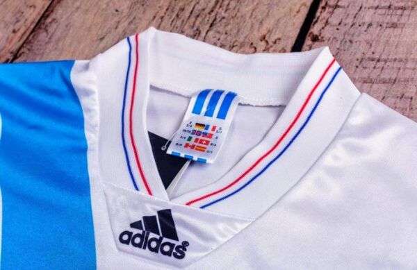 Présente le col du maillot OM Ligue des Champions 1993