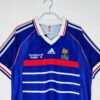 Présente la manche, col et logos du maillot vintage France Finale Coupe du Monde 1998