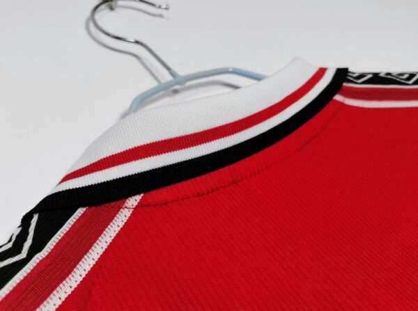 Présente le col du maillot vintage Manchester United Domicile 1998/2000