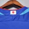 Présente le col du maillot vintage Japon Domicile Coupe du Monde 2006