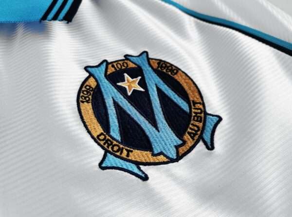 Présente le logo du maillot vintage Olympique de Marseille Domicile "Centenaire" 1998/1999
