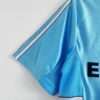 Présente la manche et coutures du maillot vintage Olympique de Marseille Extérieur "Centenaire" 1998/1999